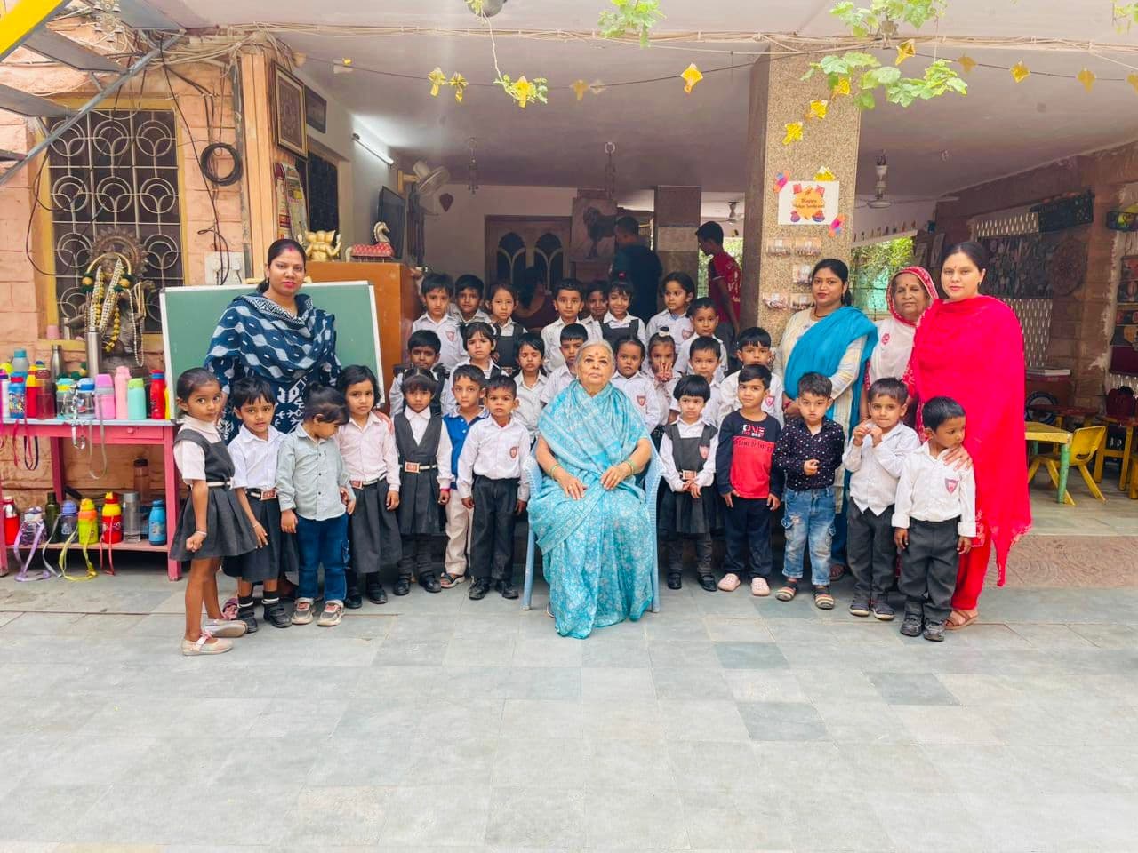 Pre-primary — teacher with Nursery in the courtyard