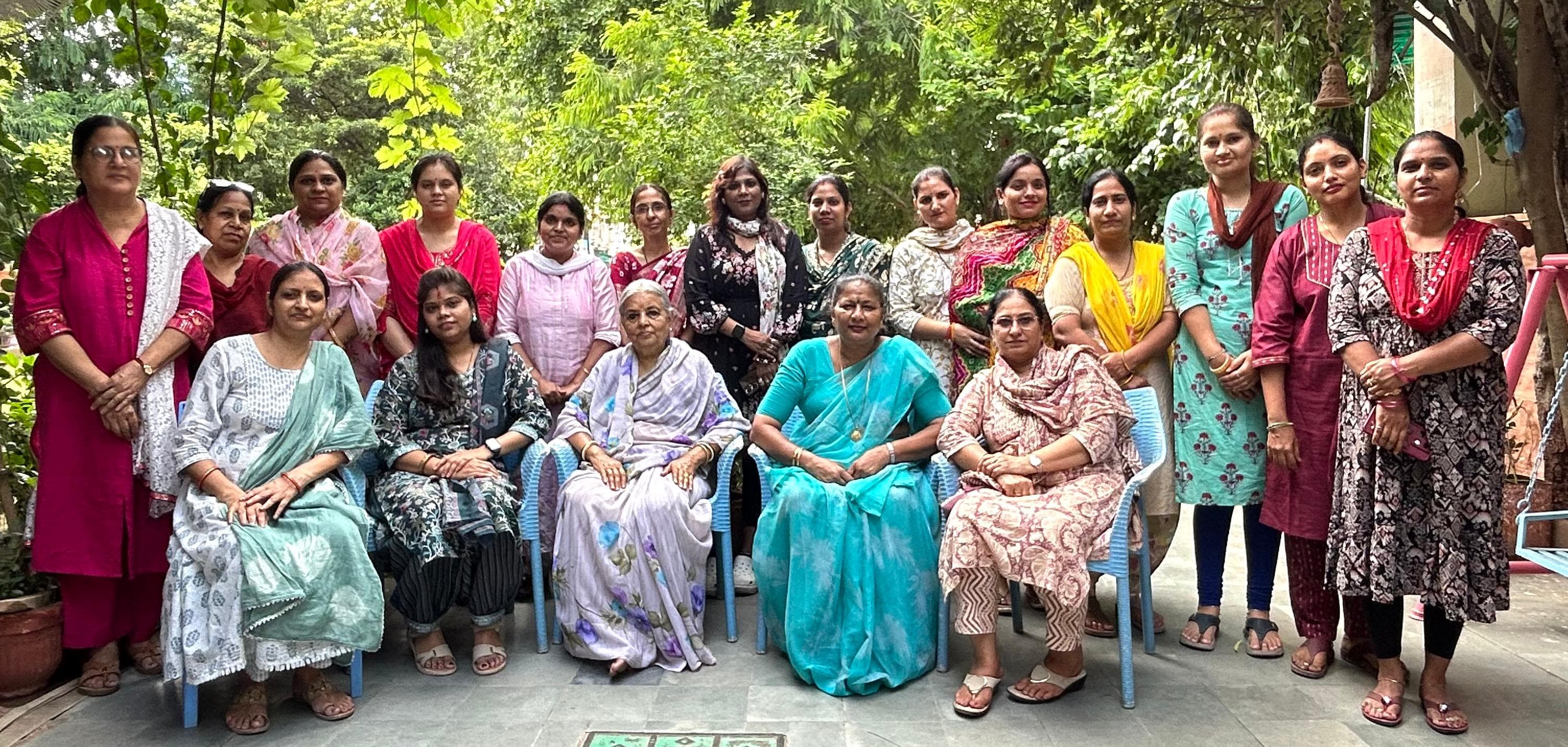 Faculty group — full staff portrait in the garden